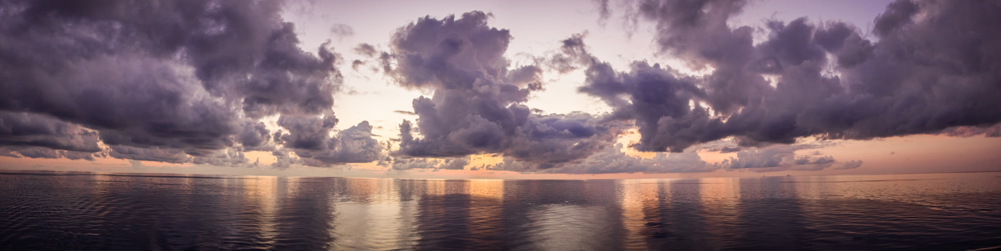 Sigma 17-70mm F2.8-4 DC Macro OS HSM sample photo. Clouds over a glassy ocean photography