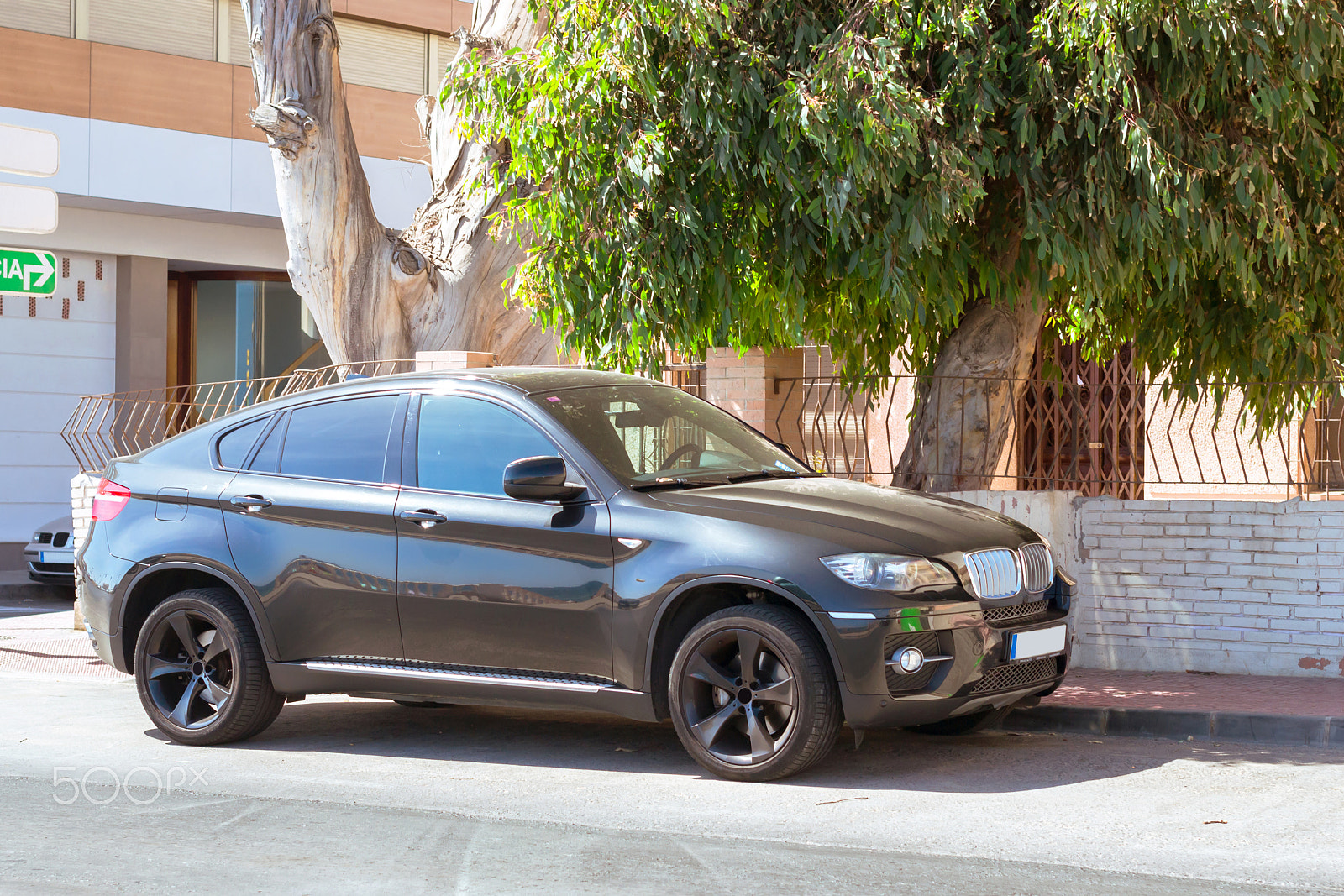 Nikon D3100 + Sigma 50mm F1.4 EX DG HSM sample photo. Black modern car bmw x6 series on sunny street, torrevieja, vale photography