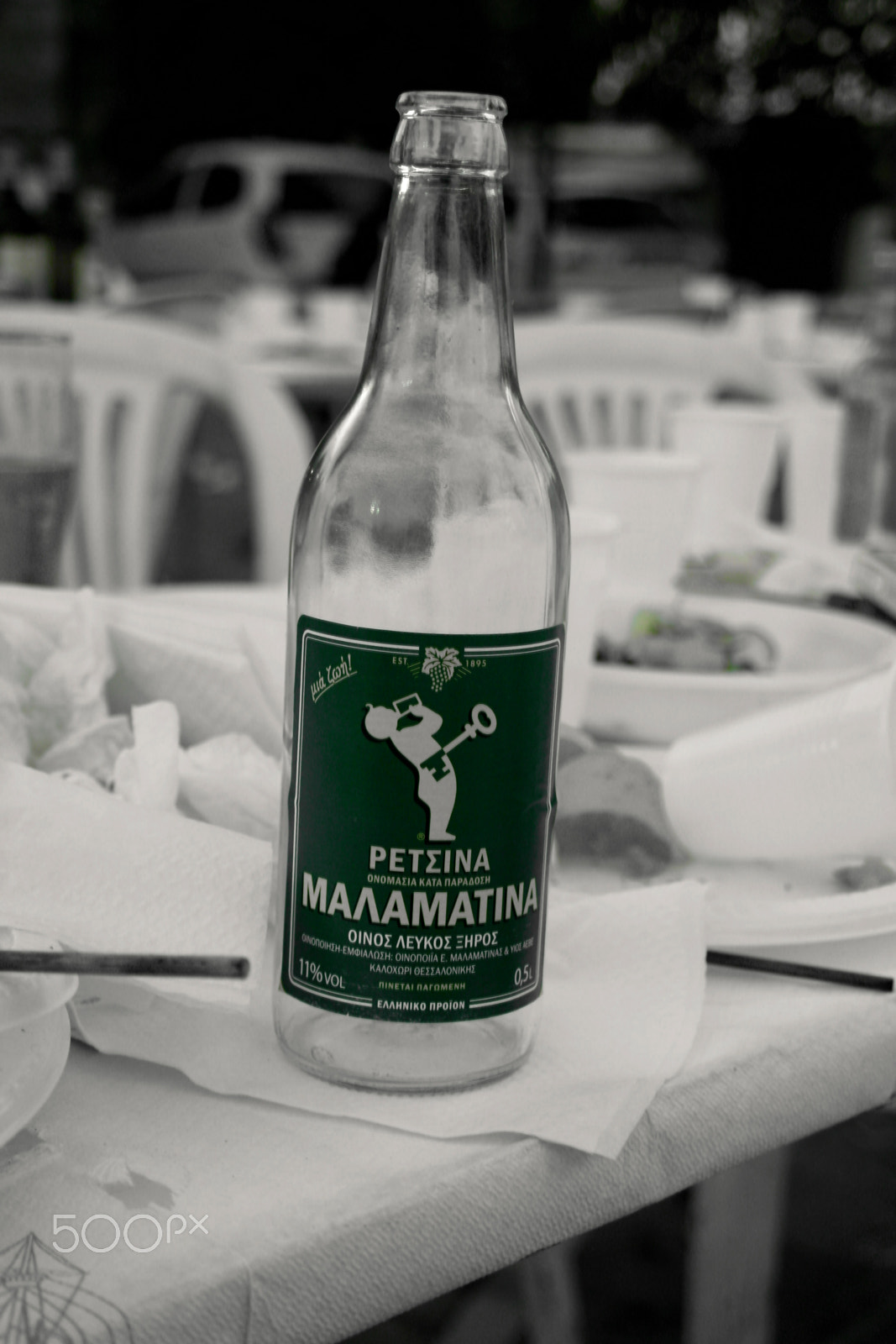 Samsung NX210 sample photo. Bottle of retsina wine after the panegyri in chios photography