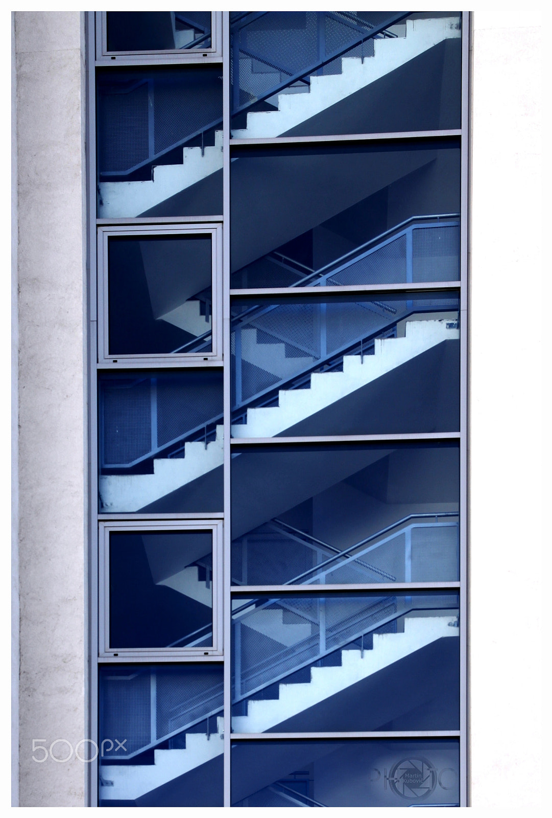 Canon EOS 50D + Canon EF 500mm F4L IS USM sample photo. Stairs behind blue glass photography