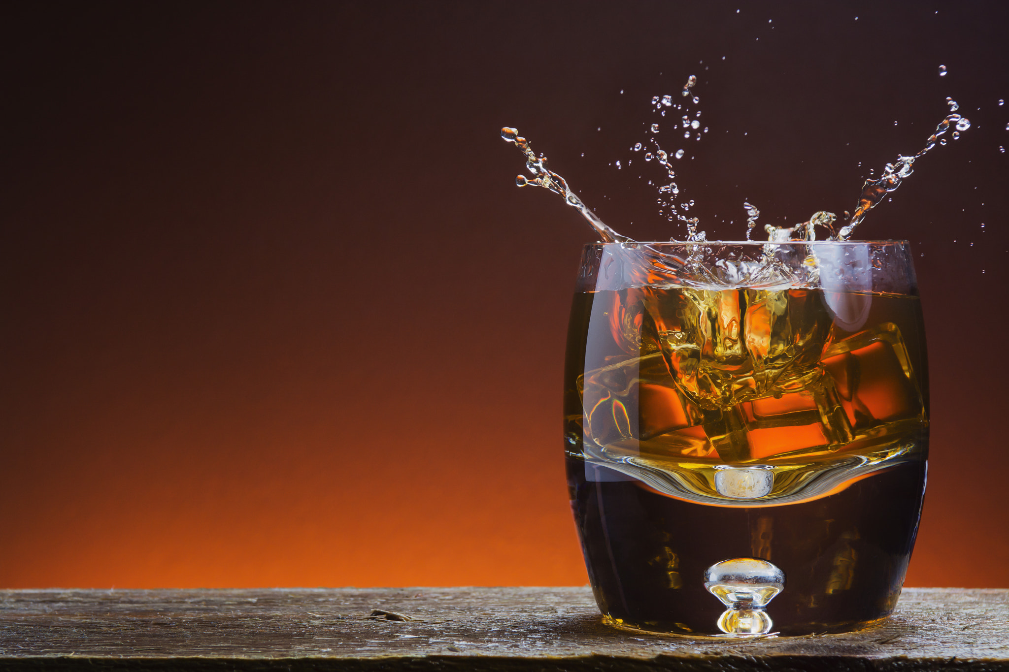 Nikon AF-S Nikkor 28-70mm F2.8 ED-IF sample photo. Rustic glass of whisky on wood with splash photography