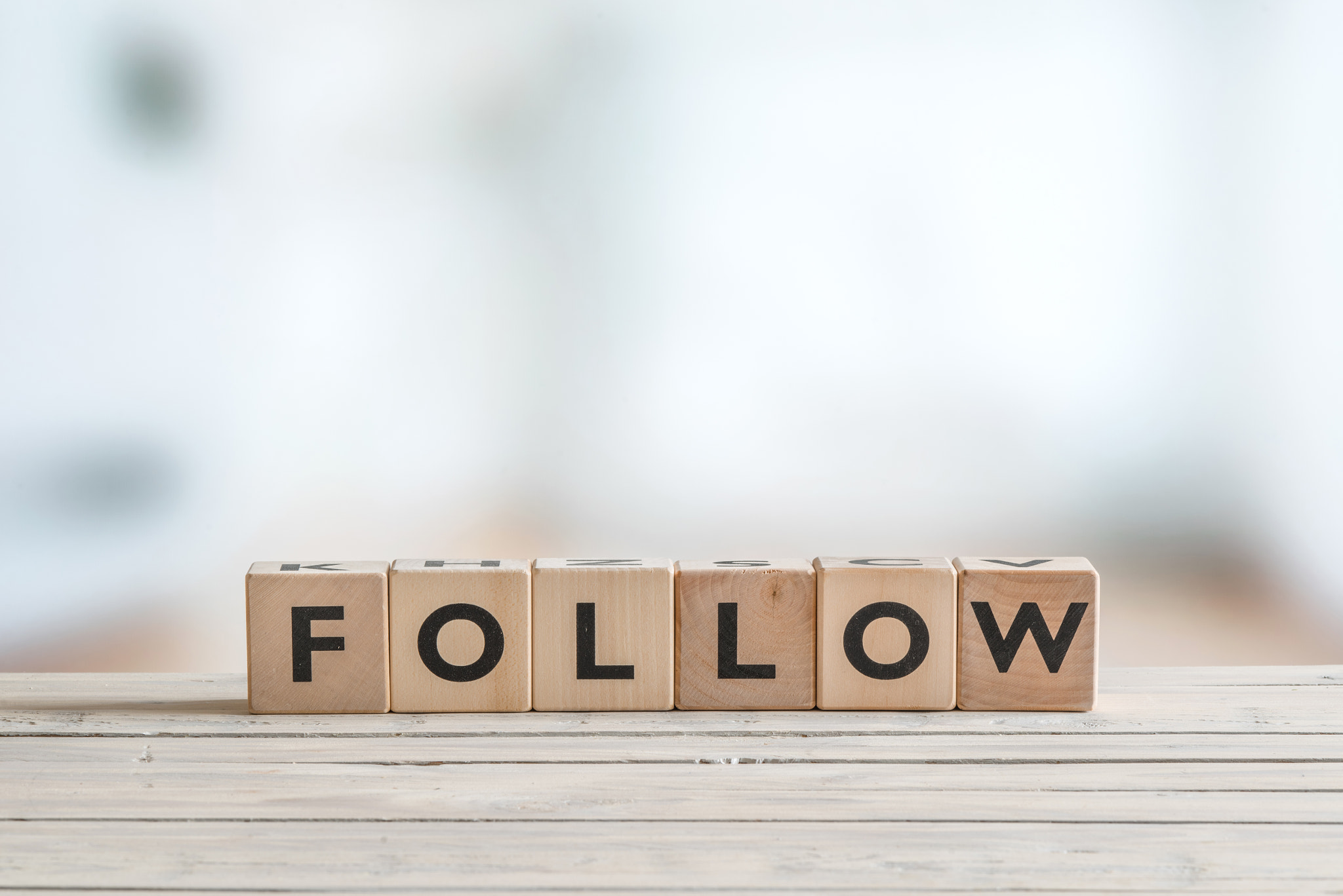 Follow sign on a wooden table