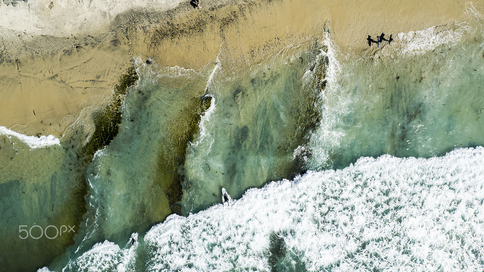 DJI FC550 + OLYMPUS M.12mm F2.0 sample photo. Surfers and paddle boarders on beach photography