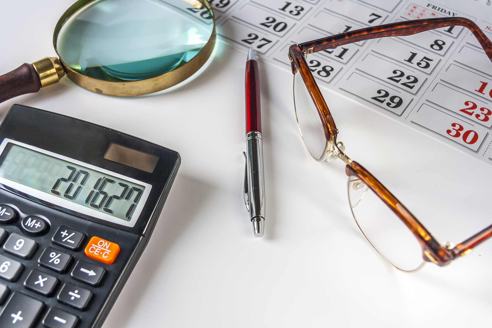 Calculator,Pen ,Magnifying Glass,Calendar And Eyeglasses