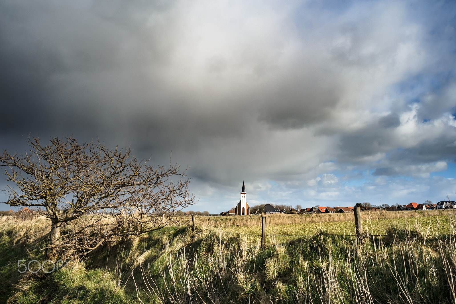 Sony Alpha DSLR-A900 + Sony 28mm F2.8 sample photo. Stormy clouds above white church, texel photography