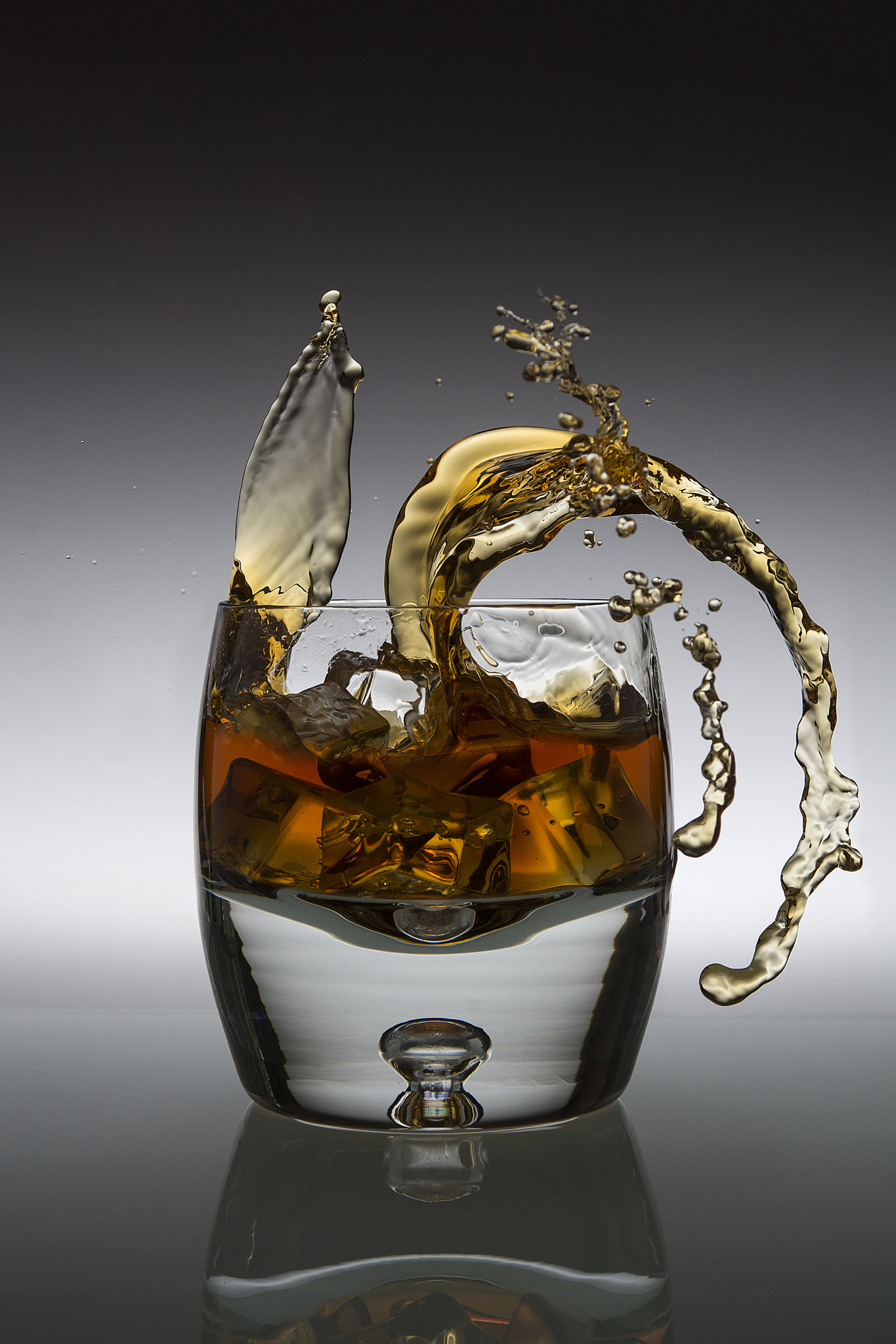 Nikon AF-S Nikkor 28-70mm F2.8 ED-IF sample photo. Amber alcoholic drink splashing in a glass photography