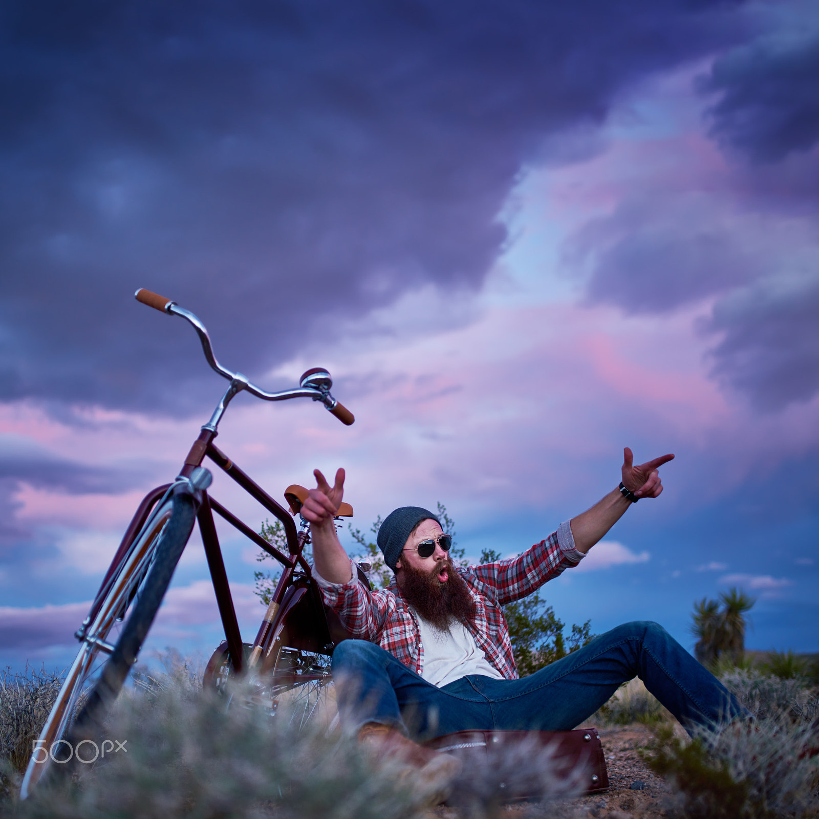 35mm F1.4 G SSM sample photo. Cool bearded traveler making hand gesture beside bike in desert photography
