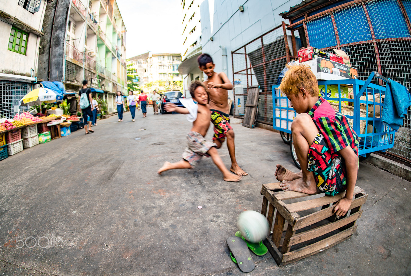 Sony a7R II + Sony 16mm F2.8 Fisheye sample photo. Boys playing football on the street photography