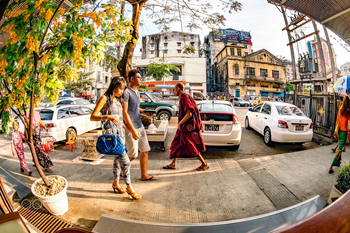 Sony a7R II + Sony 16mm F2.8 Fisheye sample photo. A young couple and a monk walking the opposite directions photography