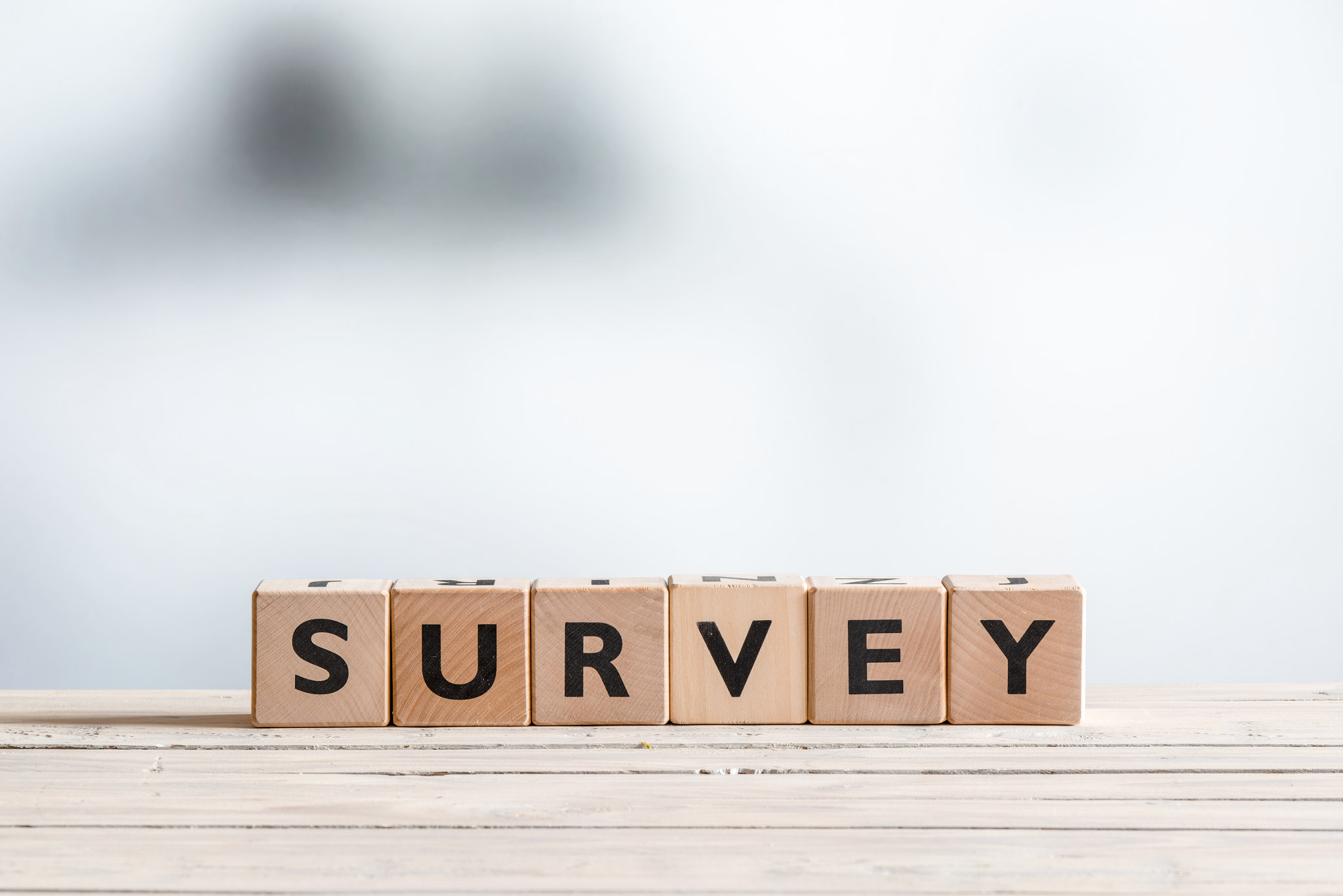 Survey sign on a wooden table