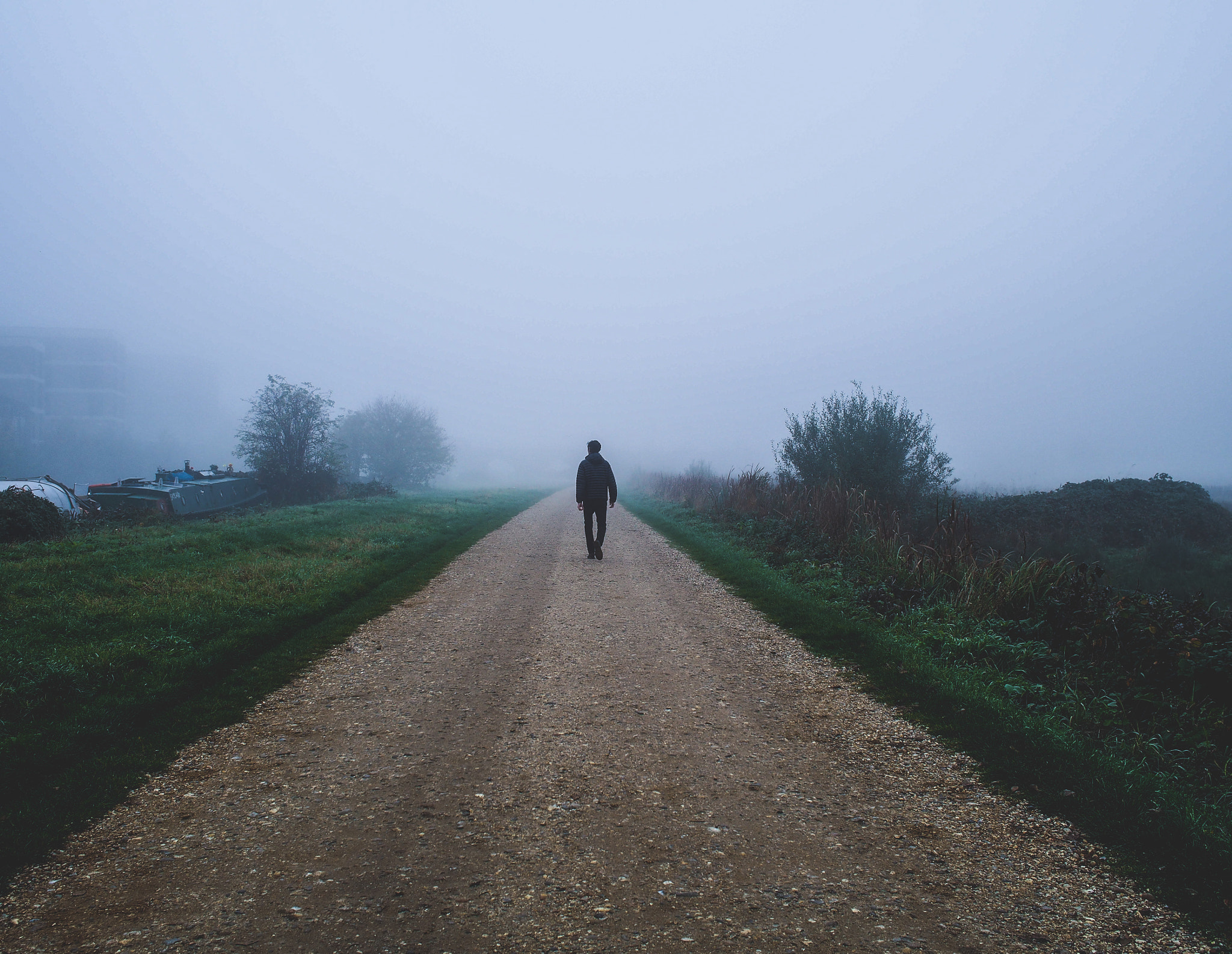 Olympus OM-D E-M5 + Olympus M.Zuiko Digital 17mm F1.8 sample photo. Man walking through the fog photography