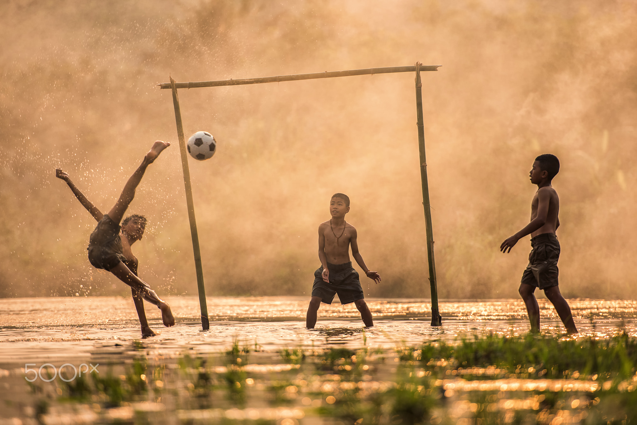 Asia Boy kicking a soccer ball