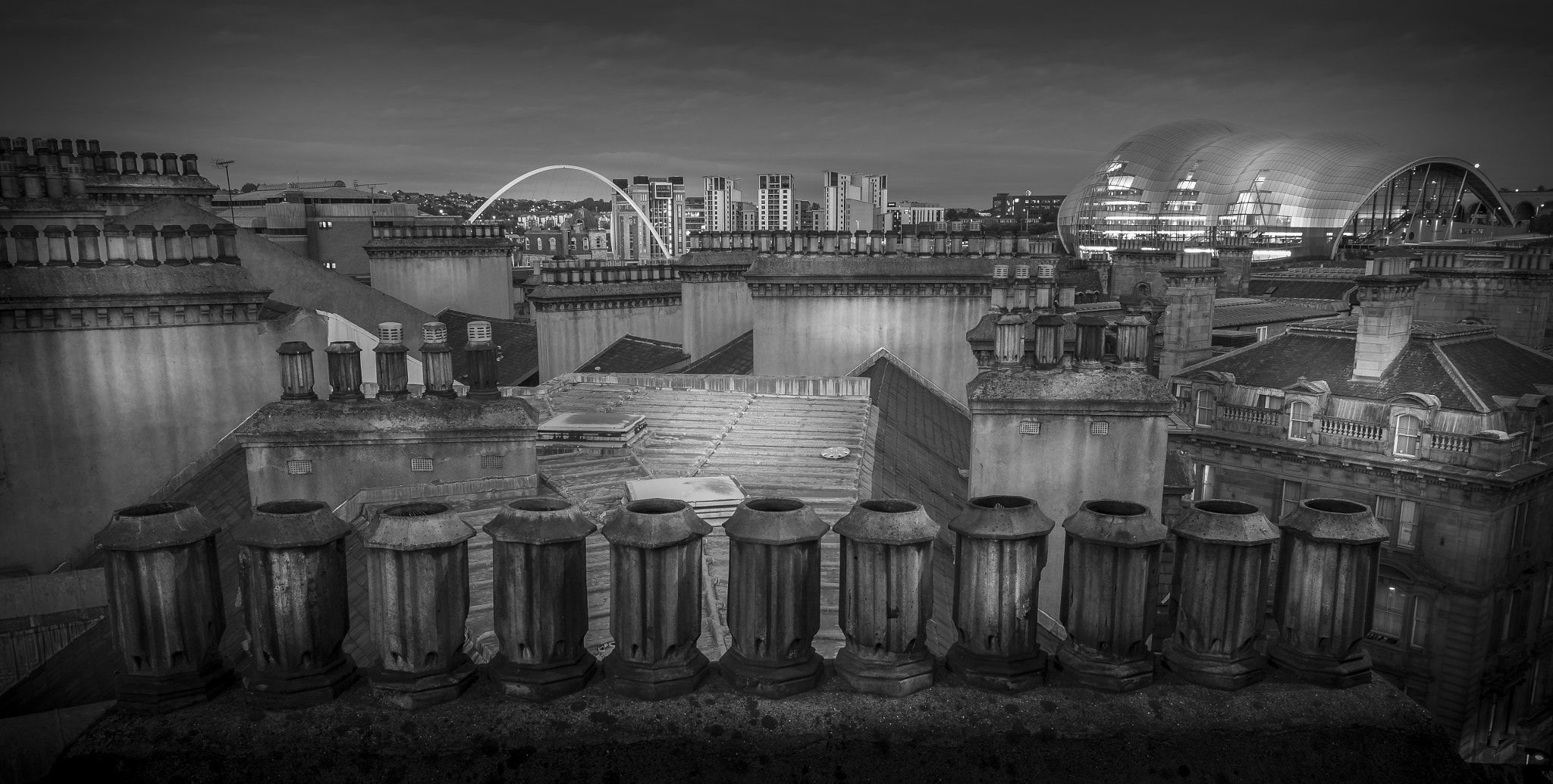 Canon EOS 700D (EOS Rebel T5i / EOS Kiss X7i) + Canon EF 16-35mm F4L IS USM sample photo. Rooftops and chimneys photography