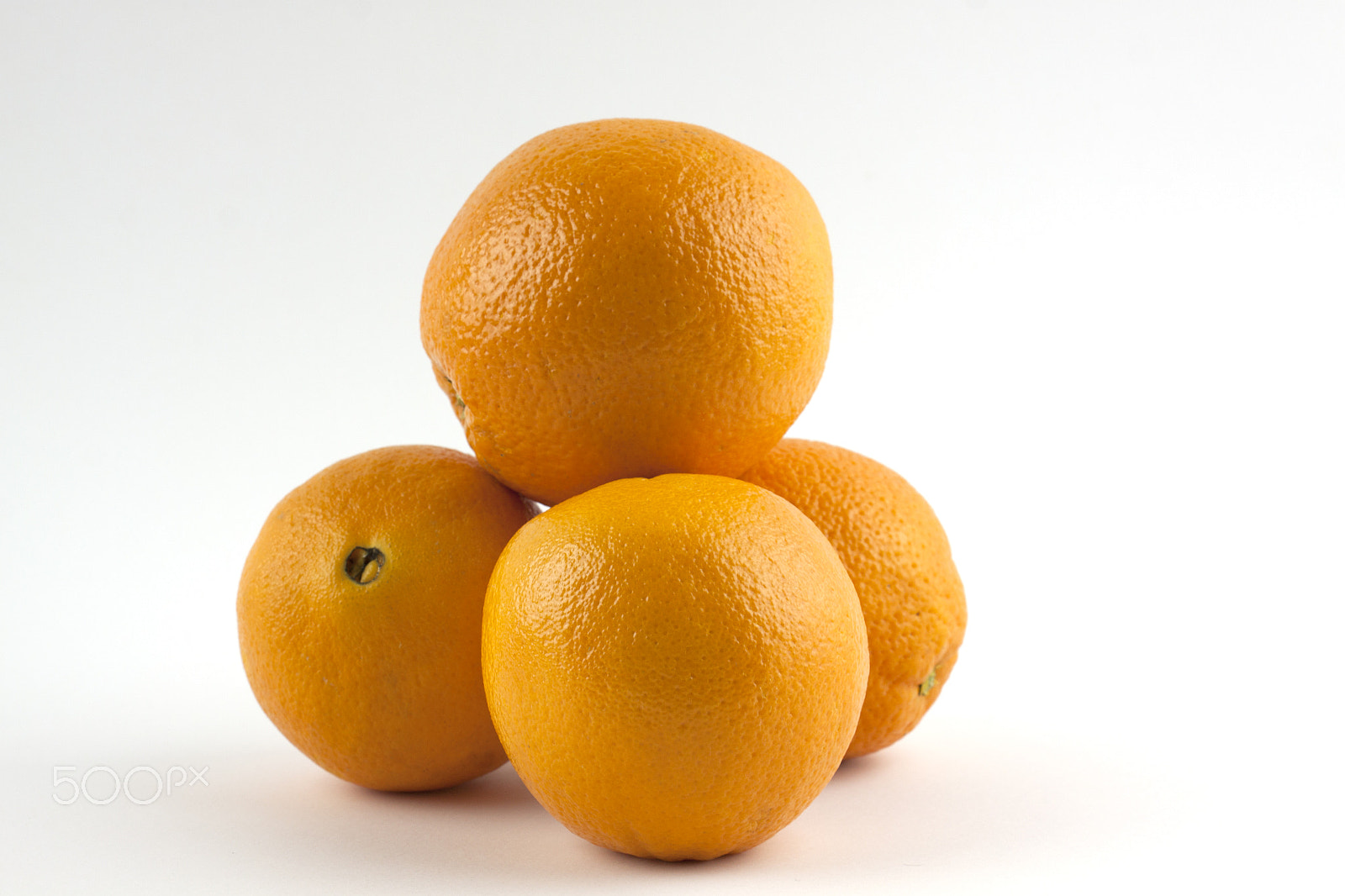 Canon EF-S 18-55mm F3.5-5.6 III sample photo. Pile of oranges isolated on white photography