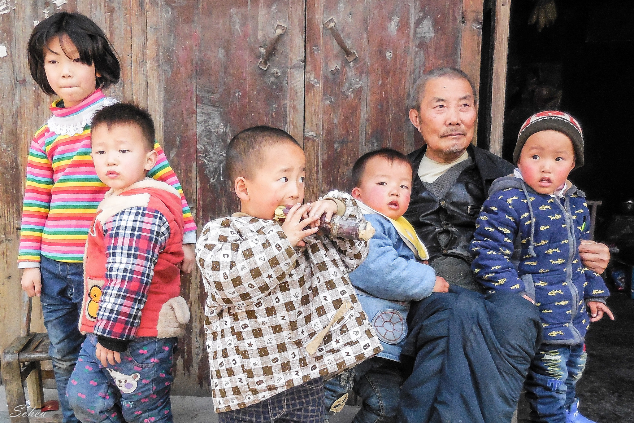 Nikon COOLPIX S6600 sample photo. Happy grandchildren with  a happy grandfather in a minority people village in china photography