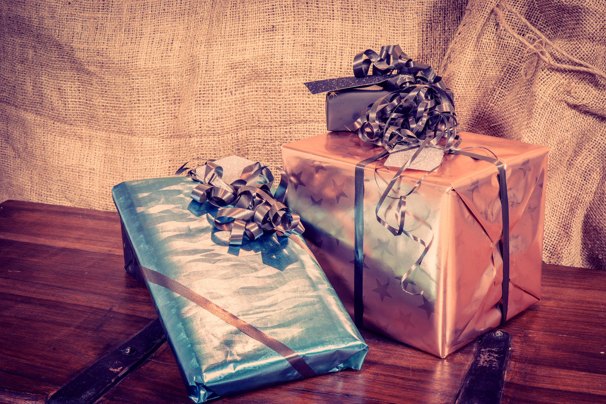 Sony a7R + Sony 50mm F1.4 sample photo. Shiny gift boxes on a wooden table photography