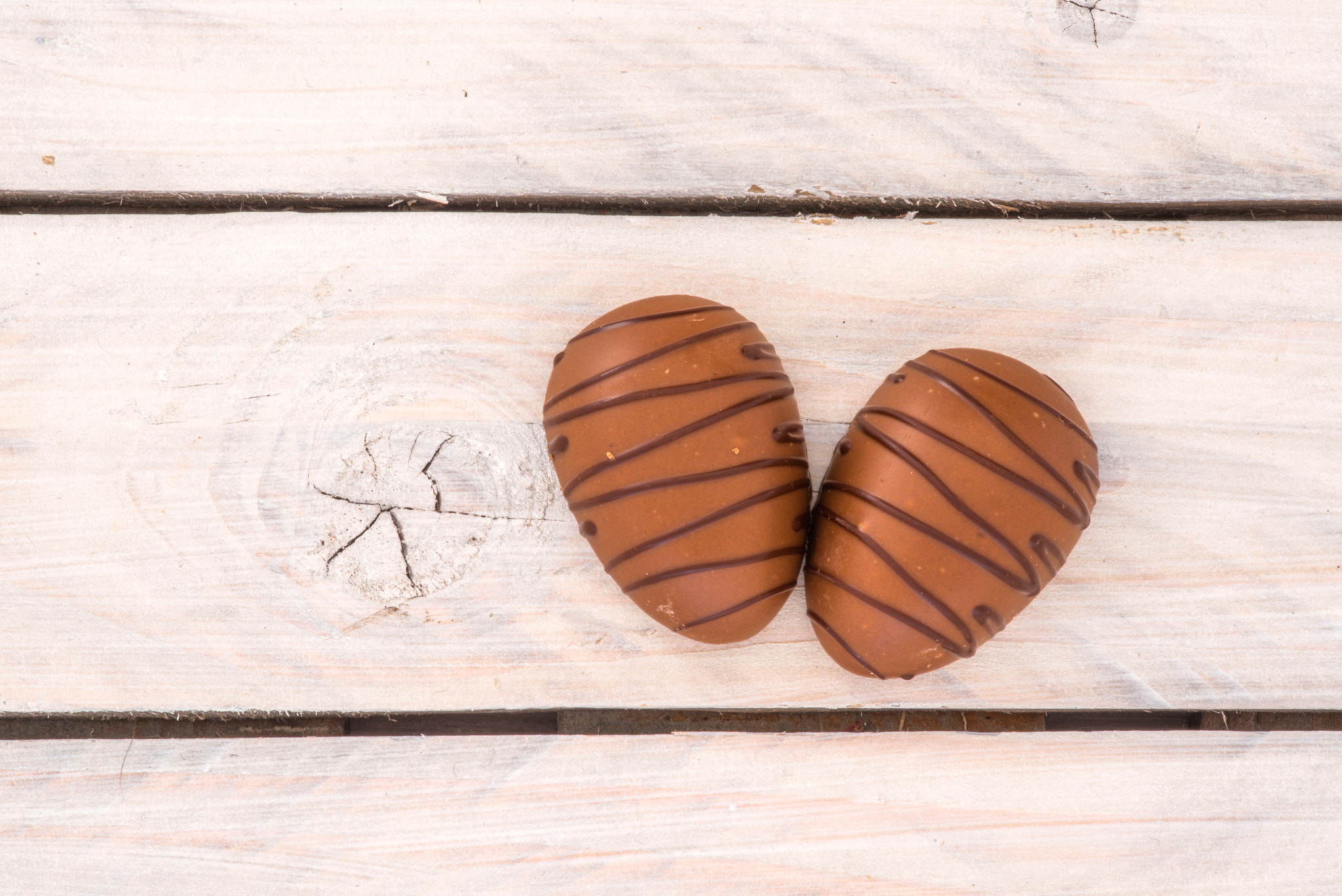 Sony a7R + Minolta AF 100mm F2.8 Macro [New] sample photo. Chocolate eggs on a wooden table photography