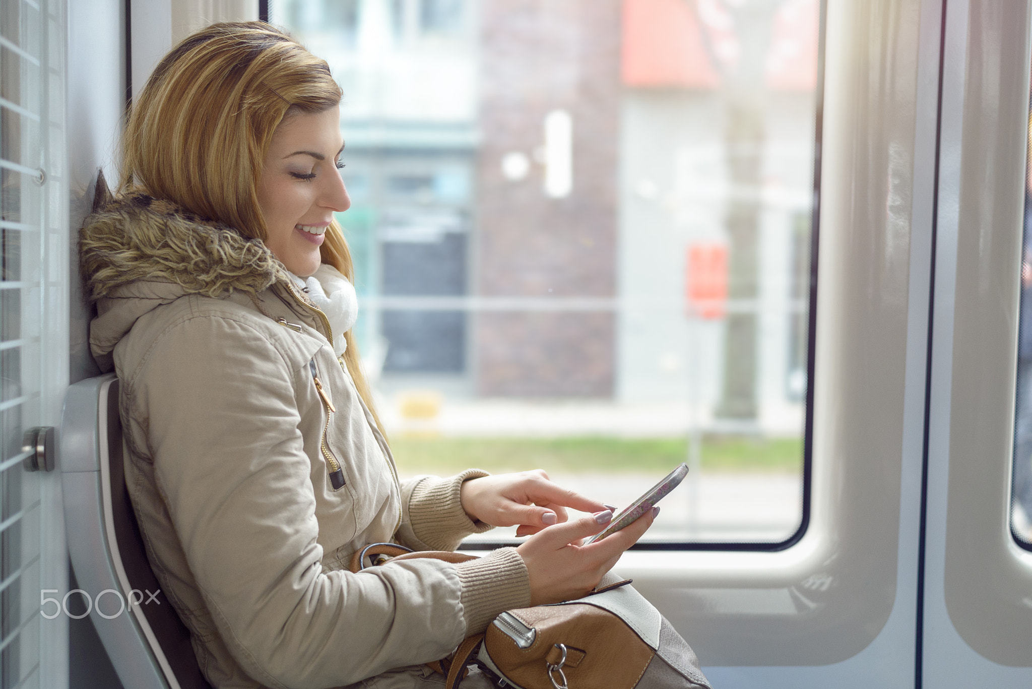 Attractive young woman riding in a train