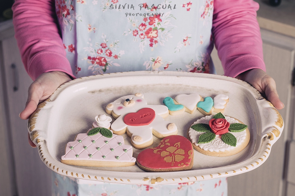 Women holding tray with delicious pastry