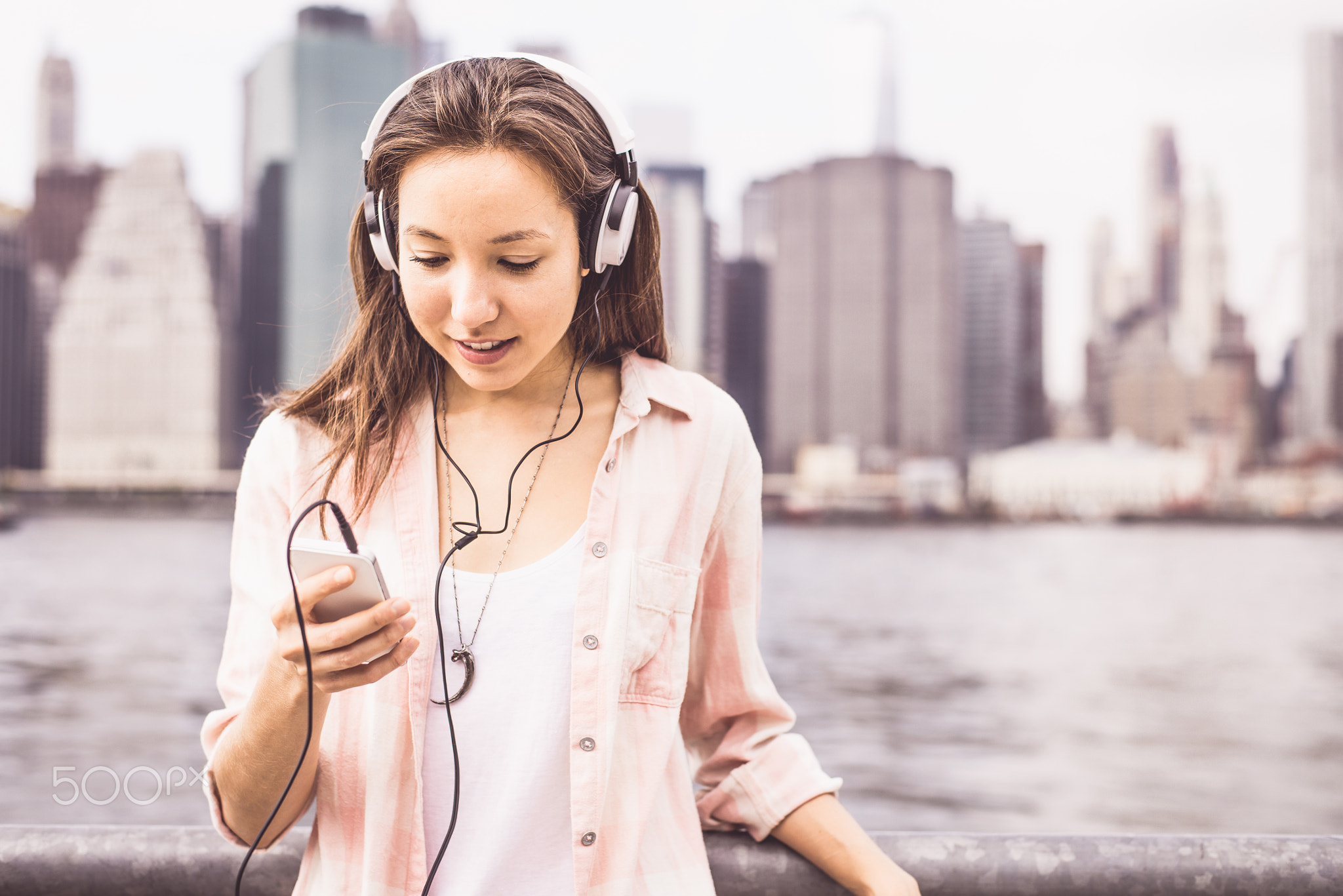 Woman listens music outdoors