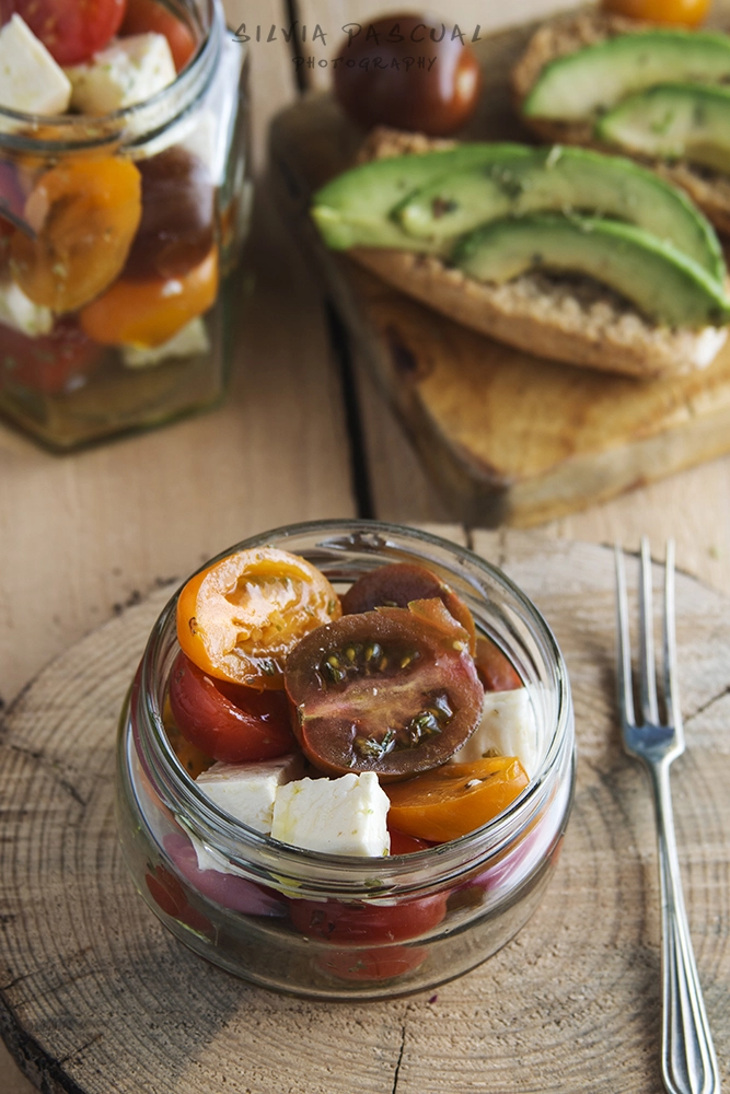 Tomatoe salad with feta cheese in glass jar