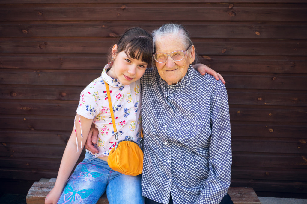 Great-grandmother, and great-granddaughter sitting arm  in arm. by ??????? ?????????? on 500px.com