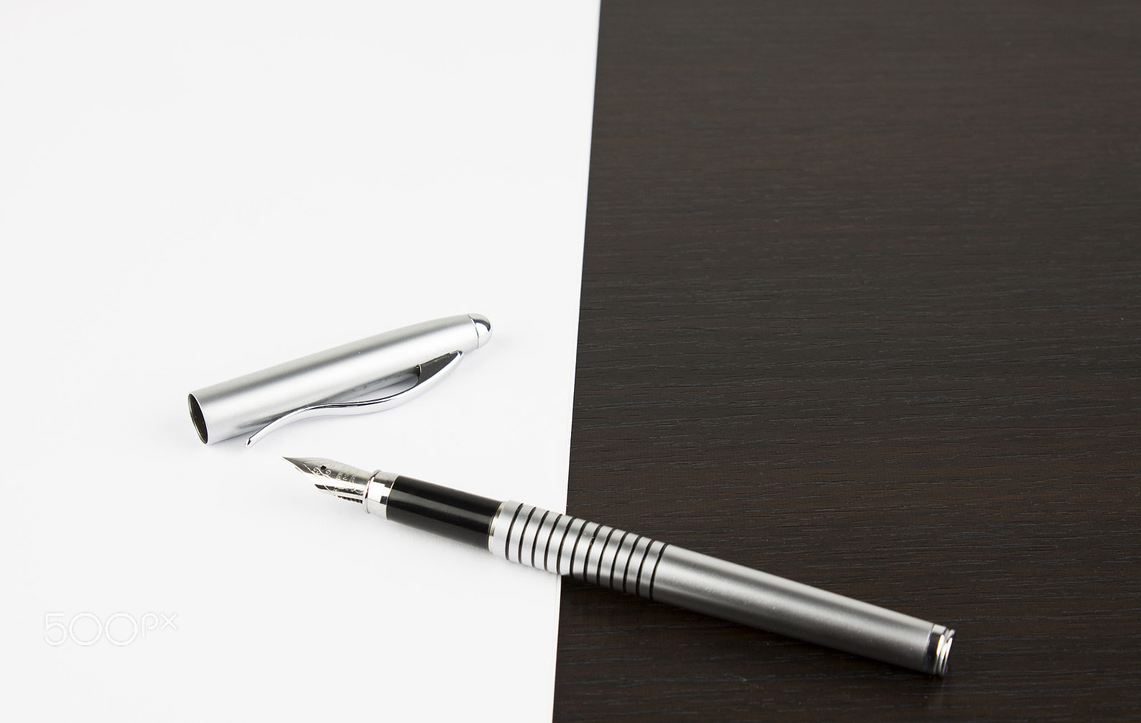 Canon EF-S 18-55mm F3.5-5.6 III sample photo. Pen and white sheet on a brown table photography