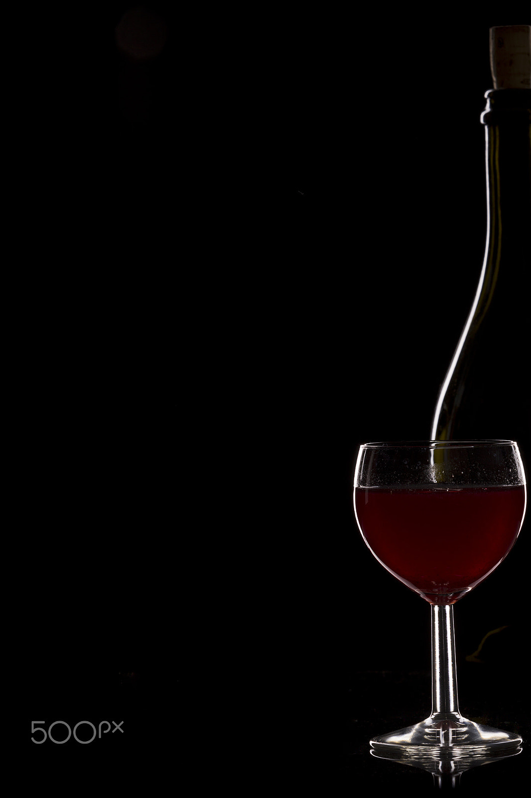 Canon EOS-1D Mark IV sample photo. Bottle of wine and a glass of wine on a black background, minima photography
