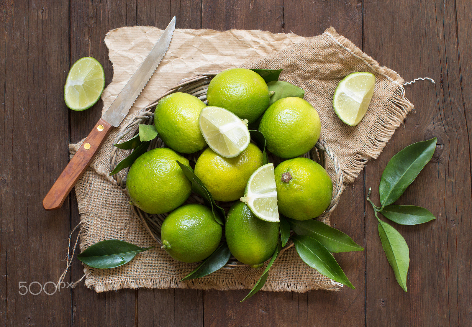 Canon EOS 650D (EOS Rebel T4i / EOS Kiss X6i) + Canon EF 50mm F1.2L USM sample photo. Fresh limes with knife photography