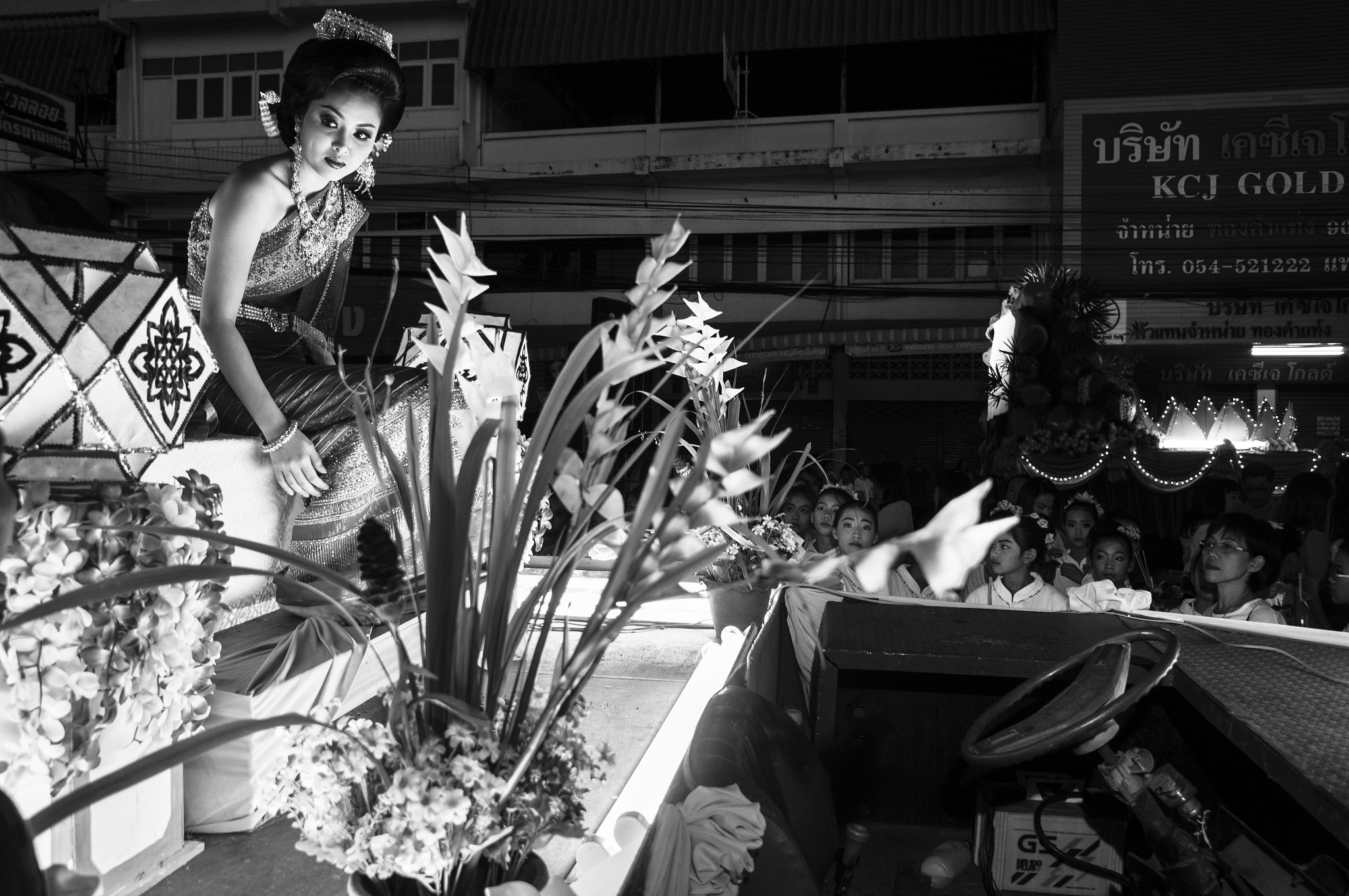 Sony Alpha NEX-5N + Sony E 20mm F2.8 sample photo. Young woman sitting on parade float photography