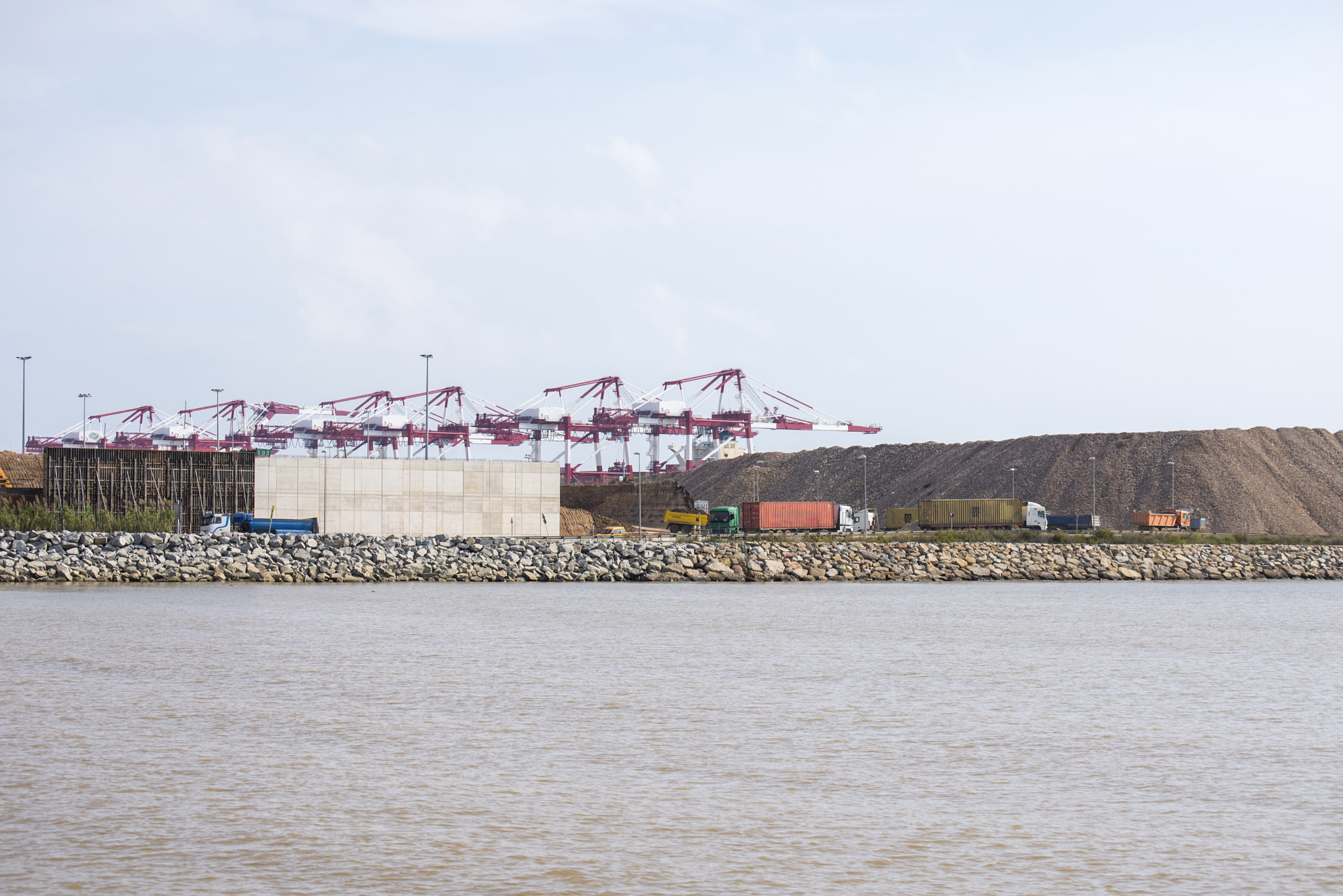 cranes and trucks in the port of Barcelona