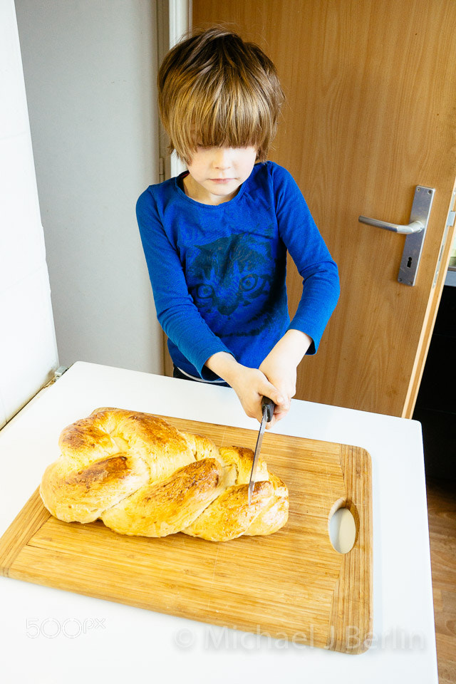 Five year old boy cutting self made bread