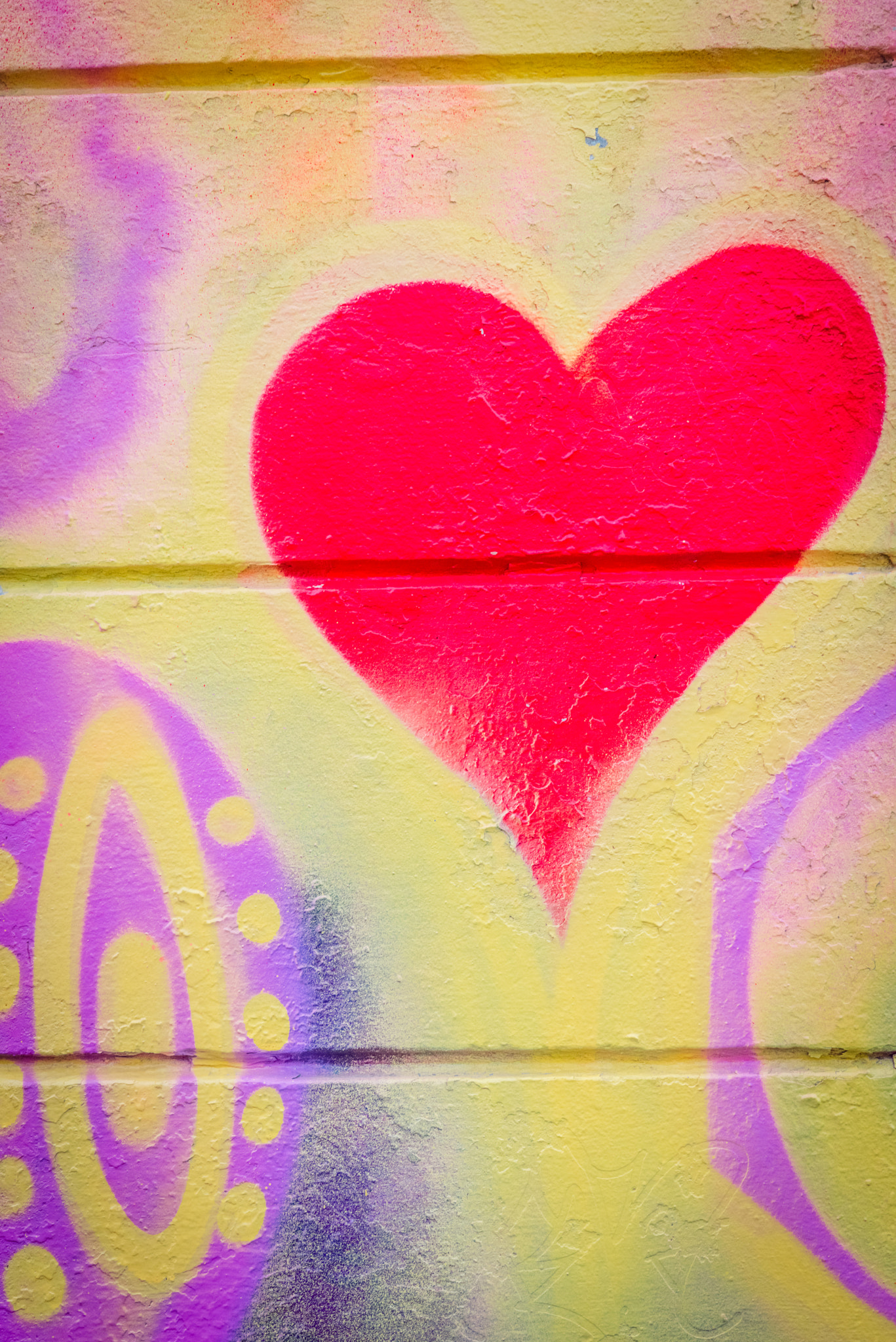 Sony a7R + Sony 50mm F1.4 sample photo. Grafitti with a heart on a concrete wall photography