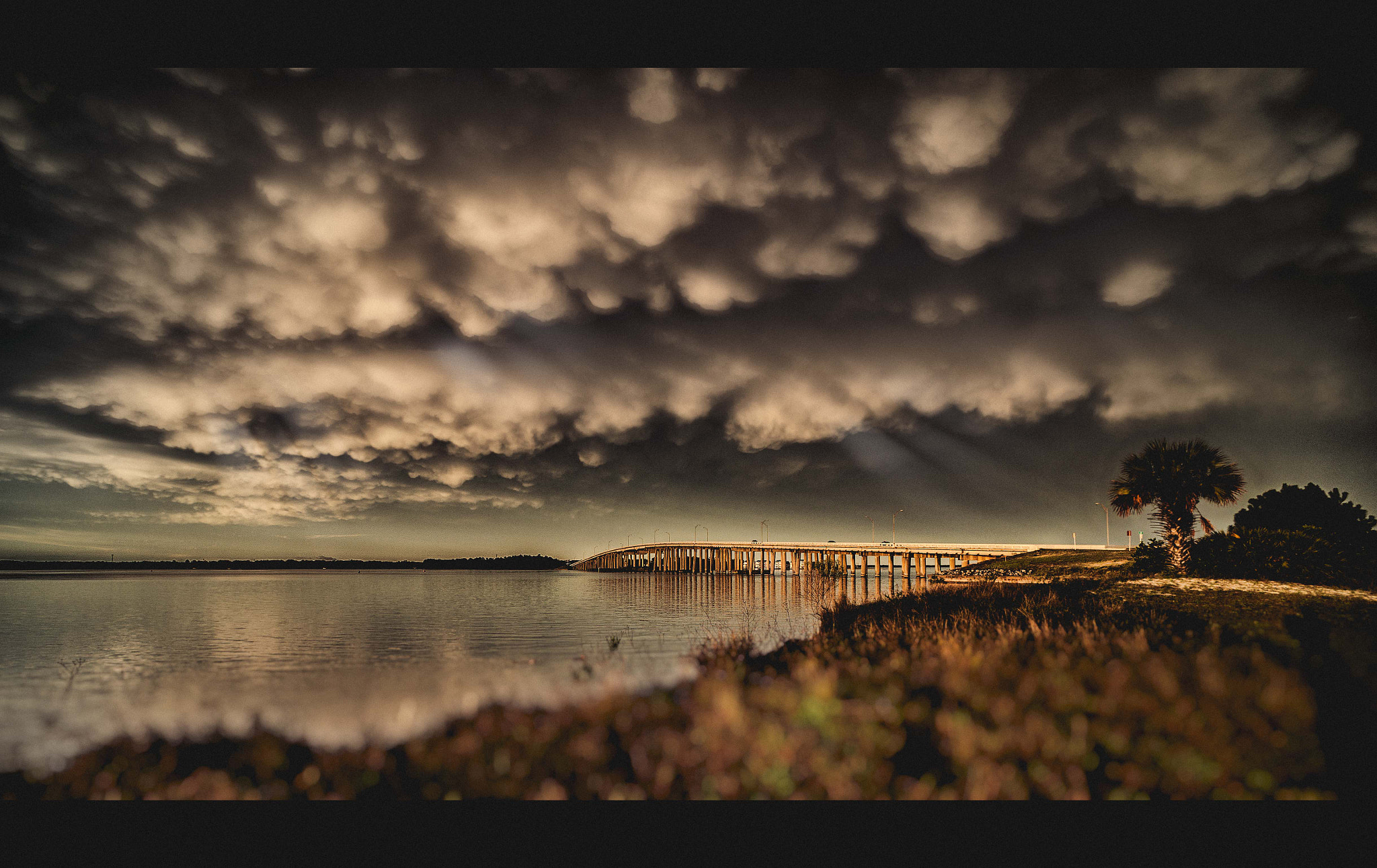 Sony Alpha NEX-3N + Sony E 16mm F2.8 sample photo. Sun rays over a distance bridge photography