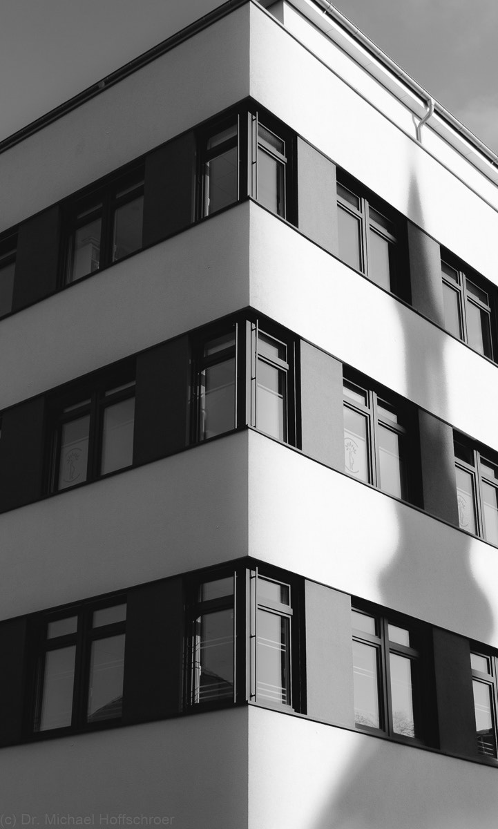 Canon EF-S 18-55mm F3.5-5.6 sample photo. House corner with shadow in black and white photography