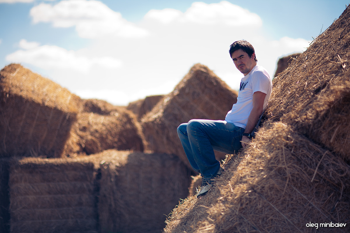 Canon EOS 5D + Canon EF 85mm F1.2L II USM sample photo. Young guy on huge cubes of hay photography