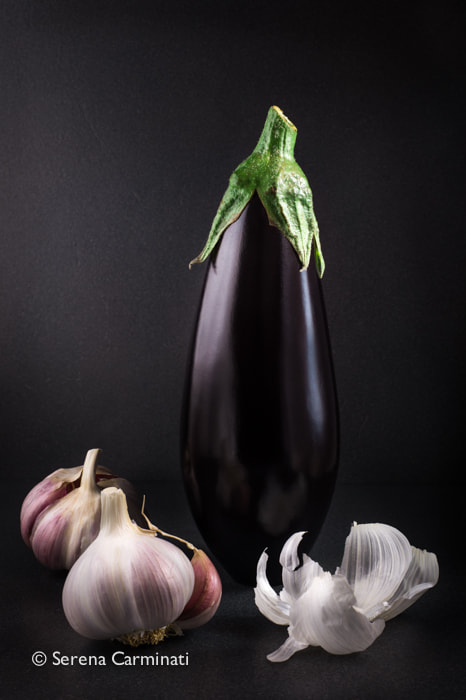 Nikon D800 + AF Nikkor 50mm f/1.8 sample photo. Aubergine with garlic on a dark background photography