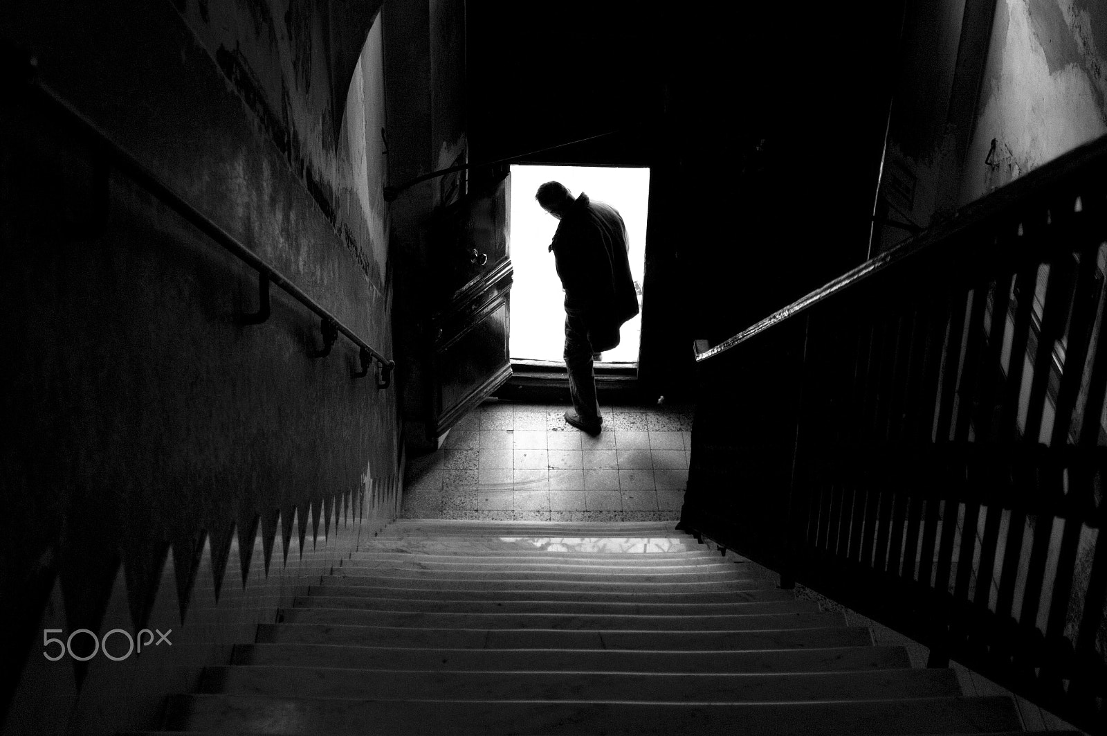 Sigma 20-40mm F2.8 sample photo. Silhouette. man coming out of the door and goes to photography