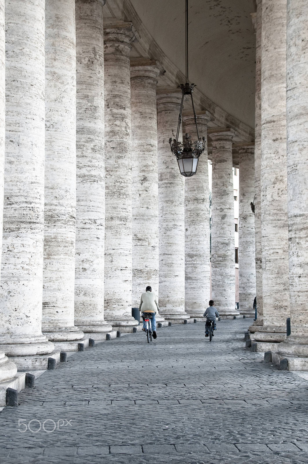 Sigma 20-40mm F2.8 sample photo. Father and son biking in san pietro. rome photography