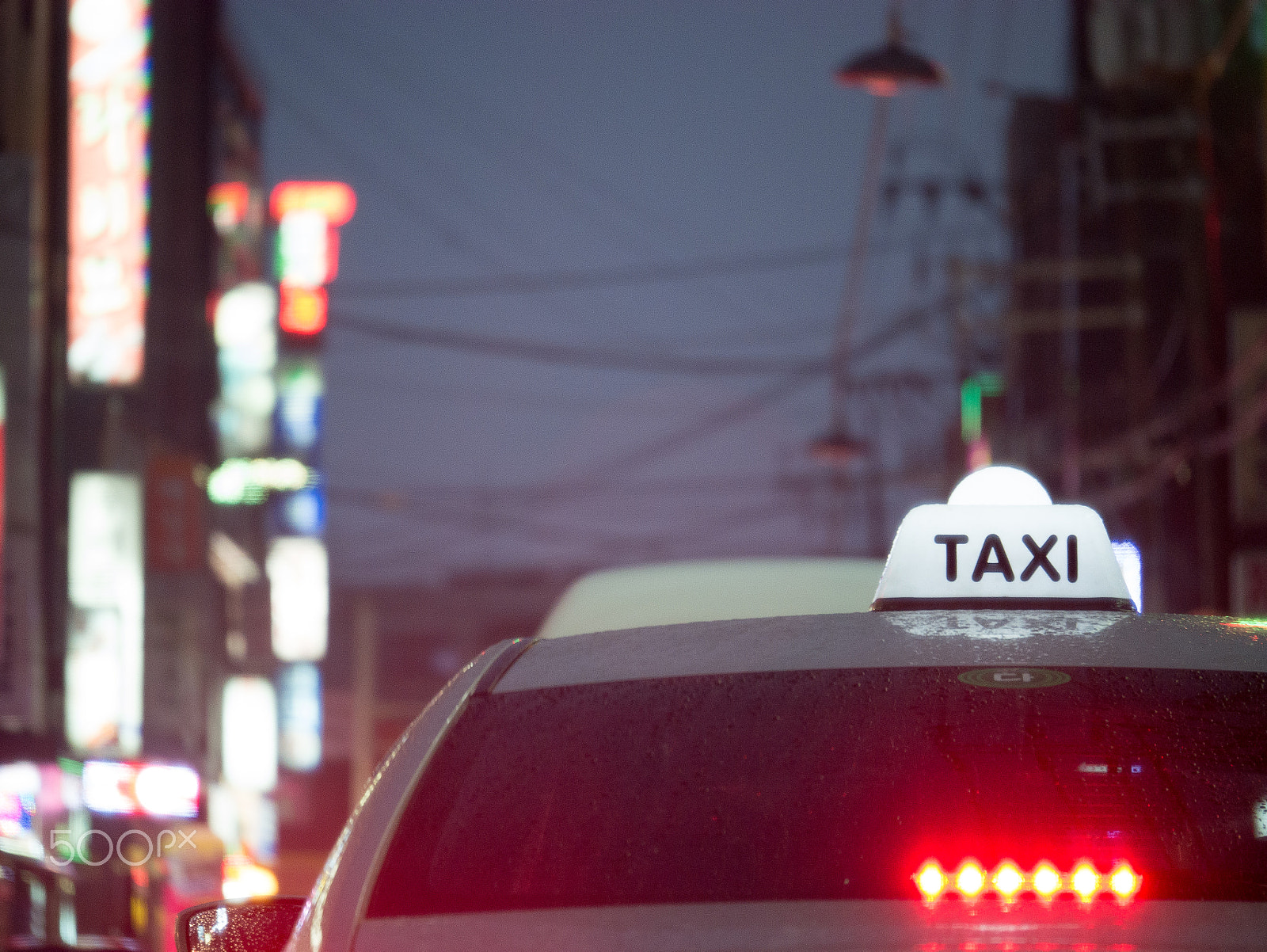 Panasonic Lumix G X Vario 35-100mm F2.8 OIS sample photo. Rainy day, taxi photography