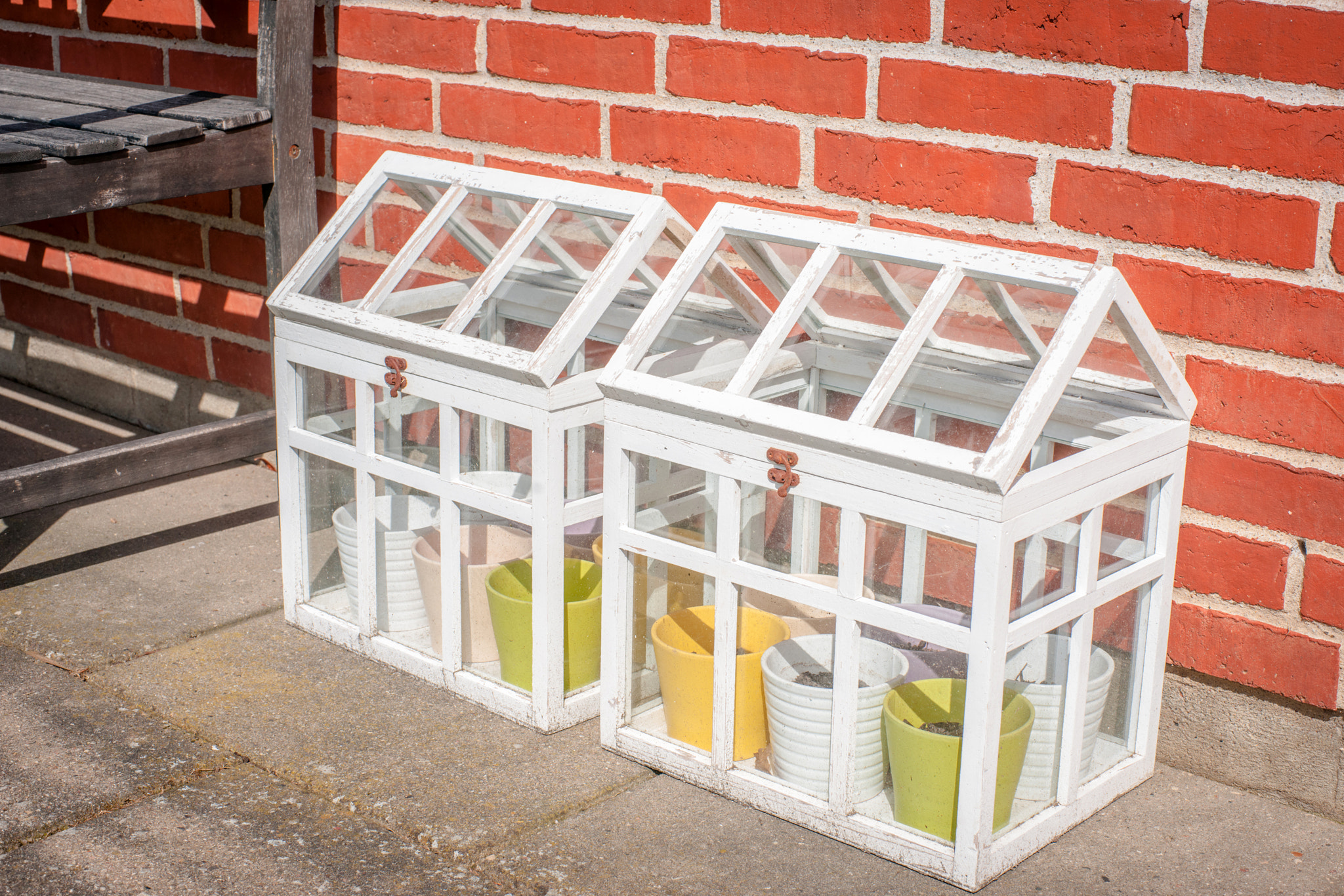 Sony 50mm F1.4 sample photo. Small outdoors greenhouse in white colors photography