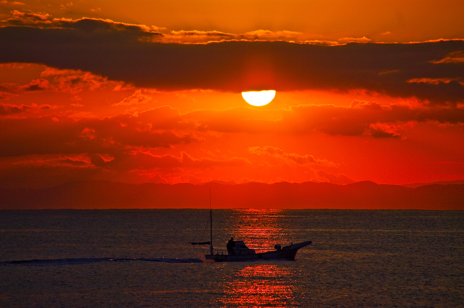 Pentax K20D sample photo. The setting sun and fishing boat photography