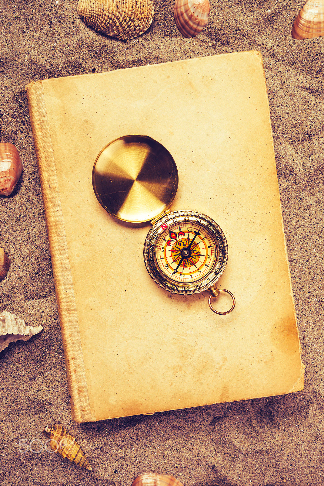 Tamron SP 15-30mm F2.8 Di VC USD sample photo. Vintage book and compass on sandy beach photography