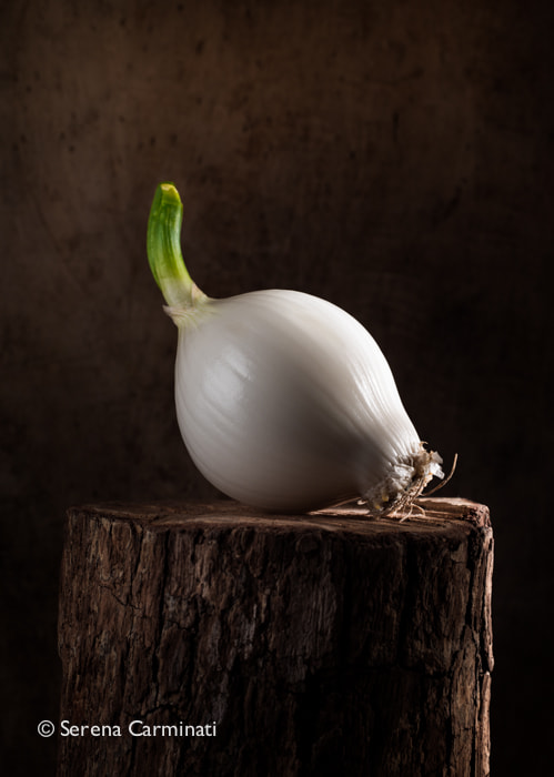 Nikon D800 + AF Nikkor 50mm f/1.8 sample photo. Young onion on wood photography