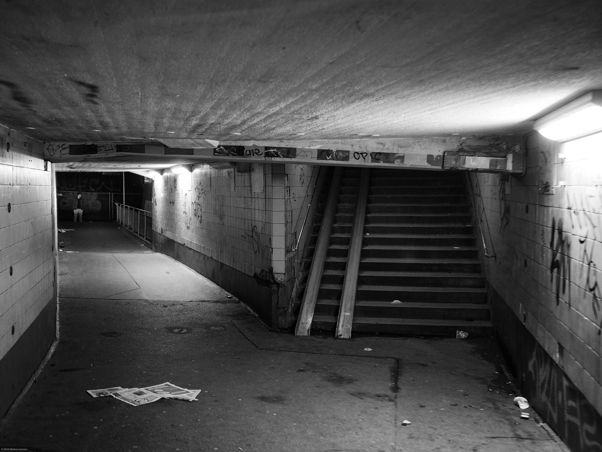 Olympus M.Zuiko Digital 17mm F1.8 sample photo. Man waiting outside underground walkway, stockholm photography