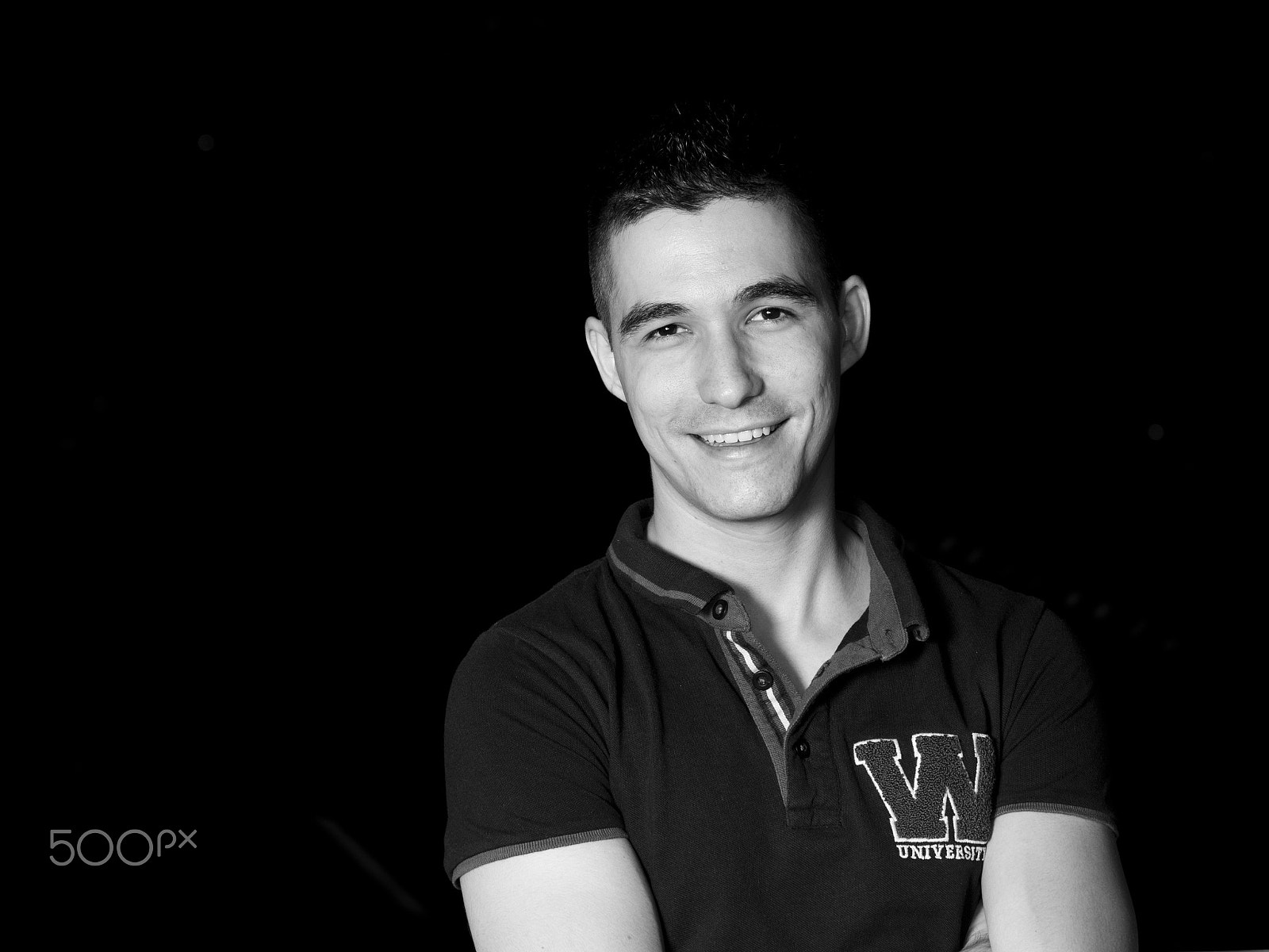Panasonic Lumix DMC-GH3 sample photo. Monochrome young man smiling with black background photography