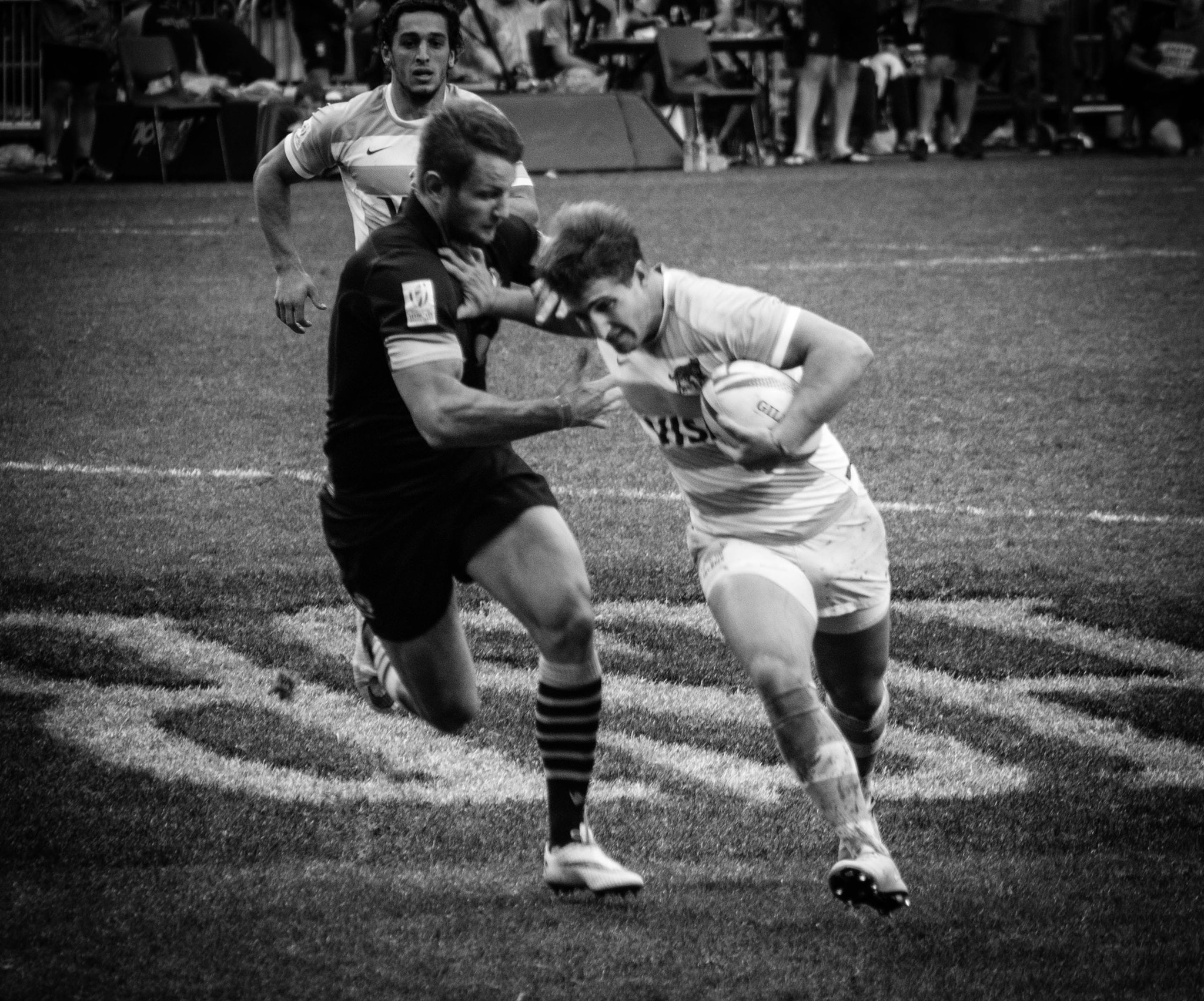 Panasonic Lumix G Vario 45-200mm F4-5.6 OIS sample photo. Rugby stiff arm photography