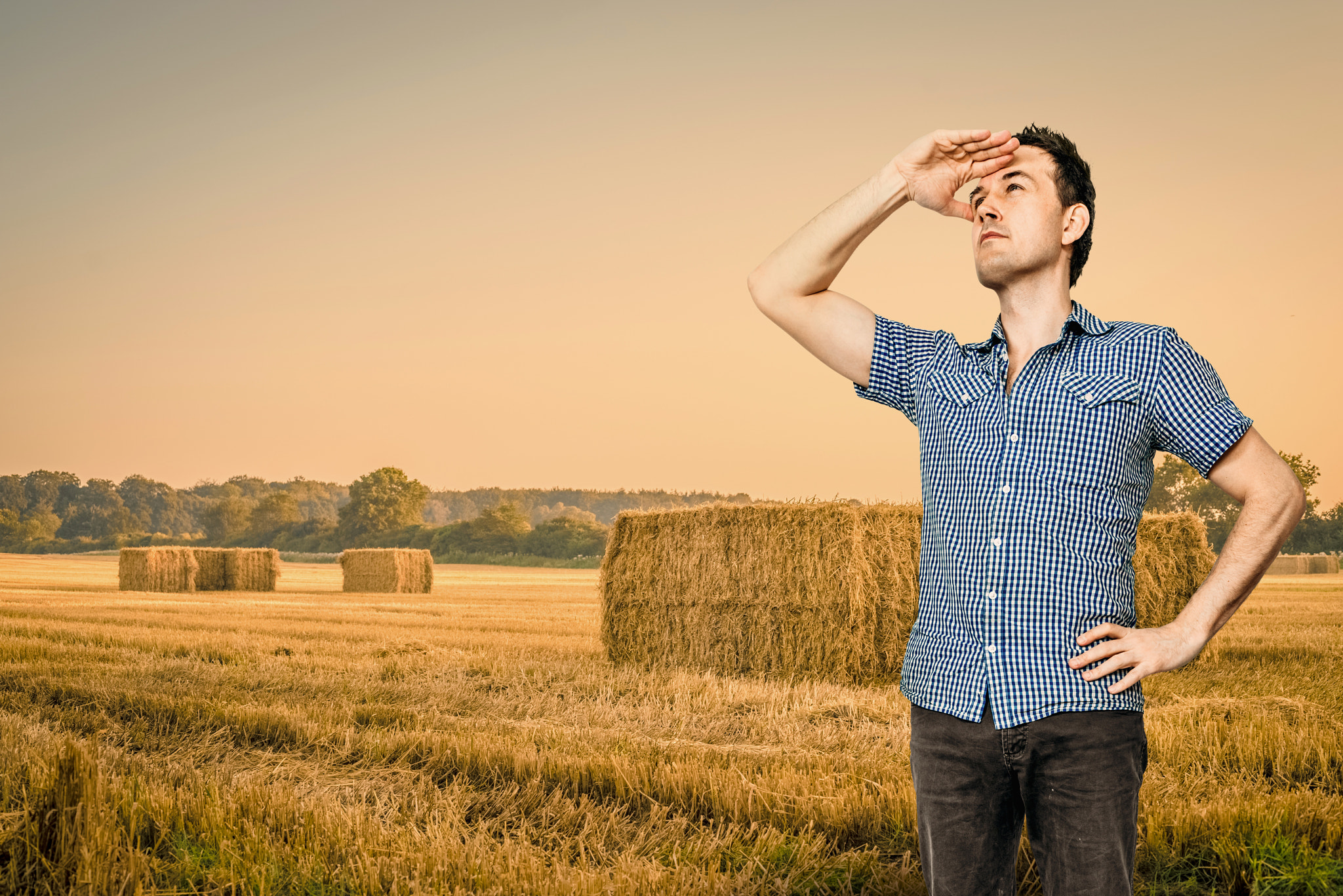 Sony a7R + Sony 50mm F1.4 sample photo. Man looking over a rural field photography