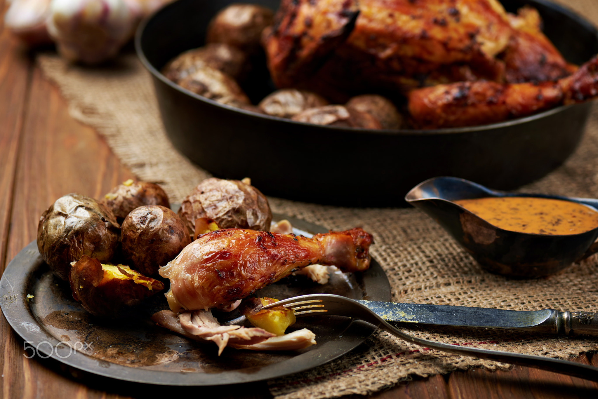 Barbecued chicken leg with baked potatoes