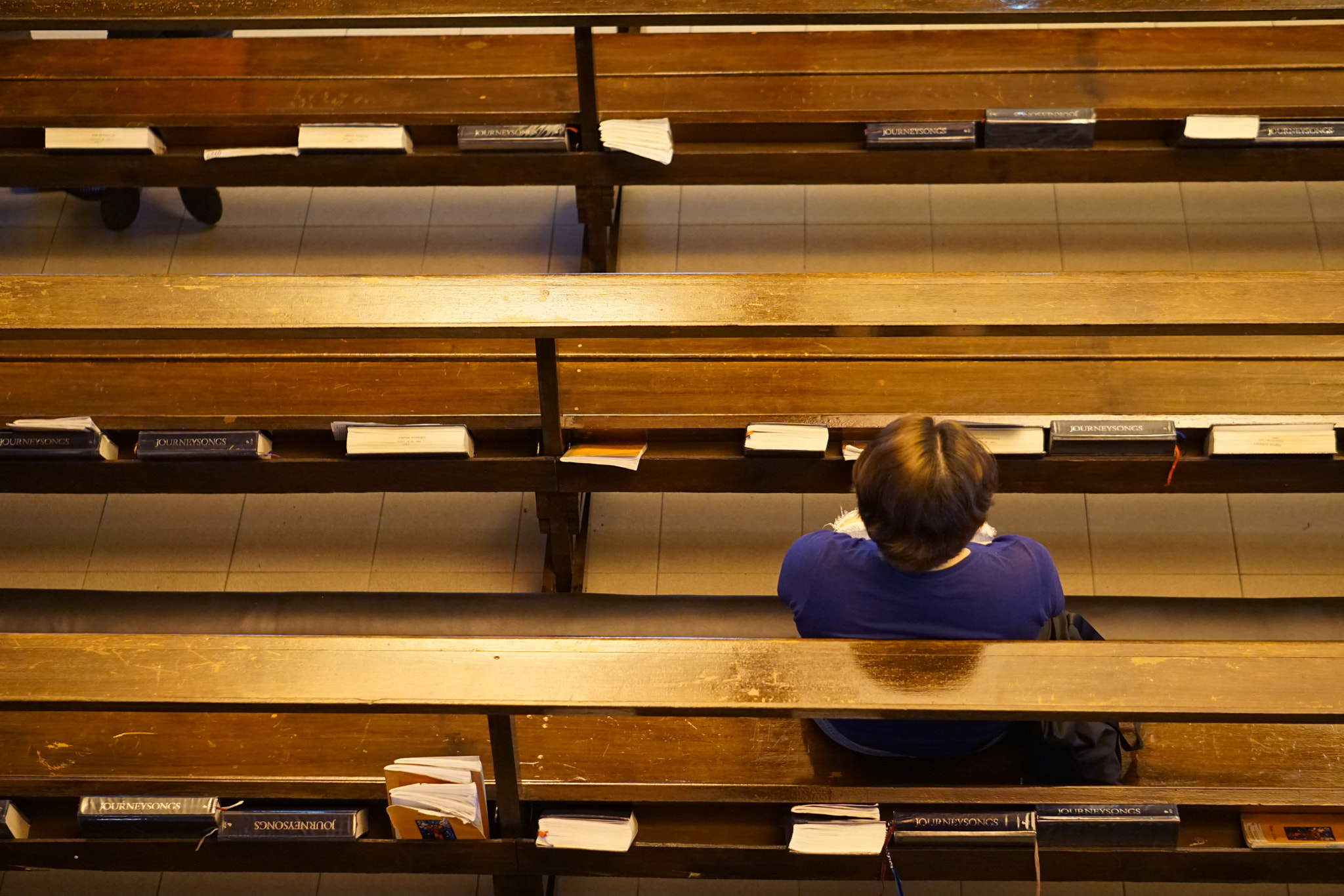 Sony a5100 + E 50mm F1.8 OSS sample photo. A woman embracing the atmosphere of the church after sunday mass photography